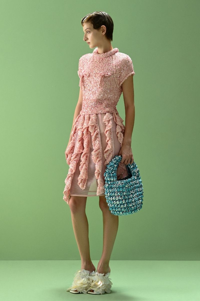 Lalo SALUE mini pink midi skirt displayed on a model, showcasing its stylish fit and vibrant color.