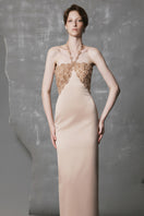 Gold long bodycon gown with sculpted bust by Phan Huy, featuring a sleek, form-fitting design and elegant detailing.