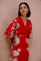 Raishma Frankie Maxi Dress displayed on a hanger, featuring a flowing, elegant design with intricate details and vibrant fabric.