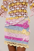 Handmade mini crochet skirt by Andreeva featuring intricate patterns and a fitted waist, perfect for casual summer wear.