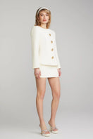 Nana Jacqueline Lisette white mini skirt with a fitted waist and short hem, styled on a model.