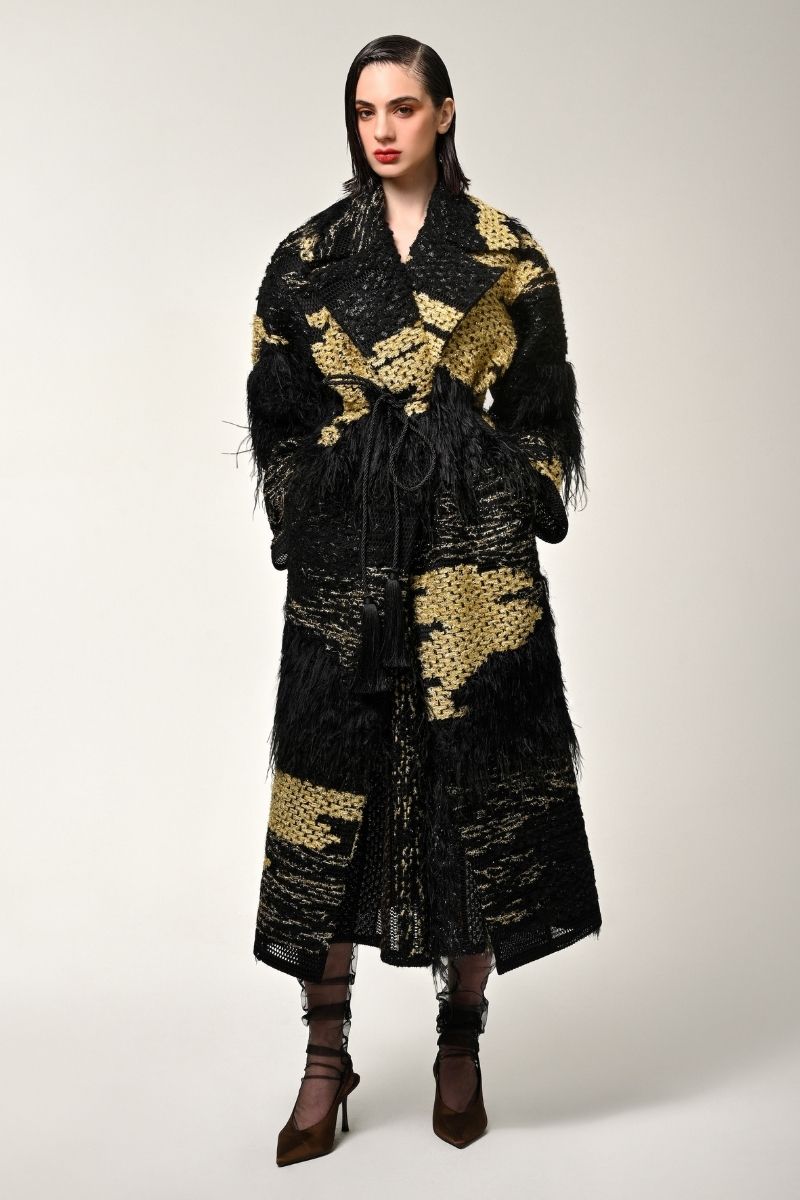 Lalo oversized black coat with gold accents, featuring a relaxed fit and stylish design, displayed on a hanger.