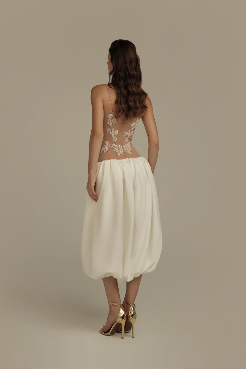 Poem Lorien midi dress in nude and white with a flowy silhouette, shown on a model. Elegant and stylish for casual or formal wear.
