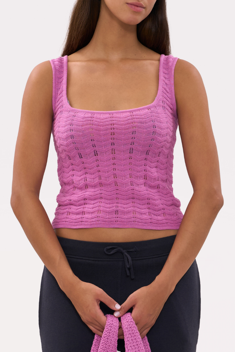 Pink La Granni Marsito top featuring a stylish design, displayed on a hanger with a soft fabric texture.