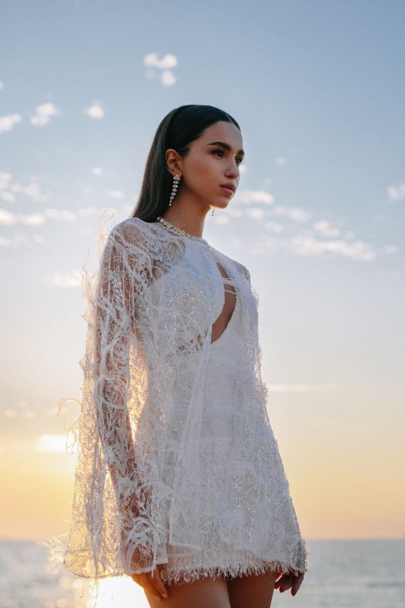Embroidered feather cape jacket by Monika Dimova featuring intricate embroidery and soft feather details, stylish and elegant outerwear.