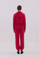 La Granni burgundy knitted roll neck hoodie sweater showing the cozy, textured fabric and relaxed fit.