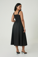 Black Luna midi dress by Summer Away displayed on a hanger, showcasing its sleek design and midi length.