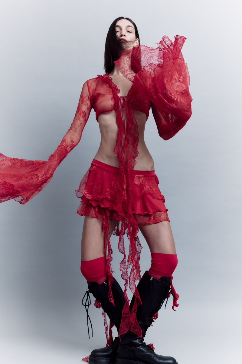 Sudi Etuz lace tie-up top featuring a fitted design with lace details and long sleeves, displayed on a plain background.