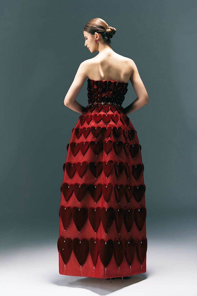 HAPPY CLOTHING CULT MIA X burgundy gown with embellished heart motif, featuring elegant design and flowing fabric.