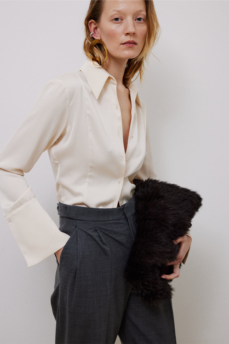 Gray pleated pants by TAGG, showcasing a relaxed fit with crisp pleats and tailored waistband for a stylish, comfortable look.