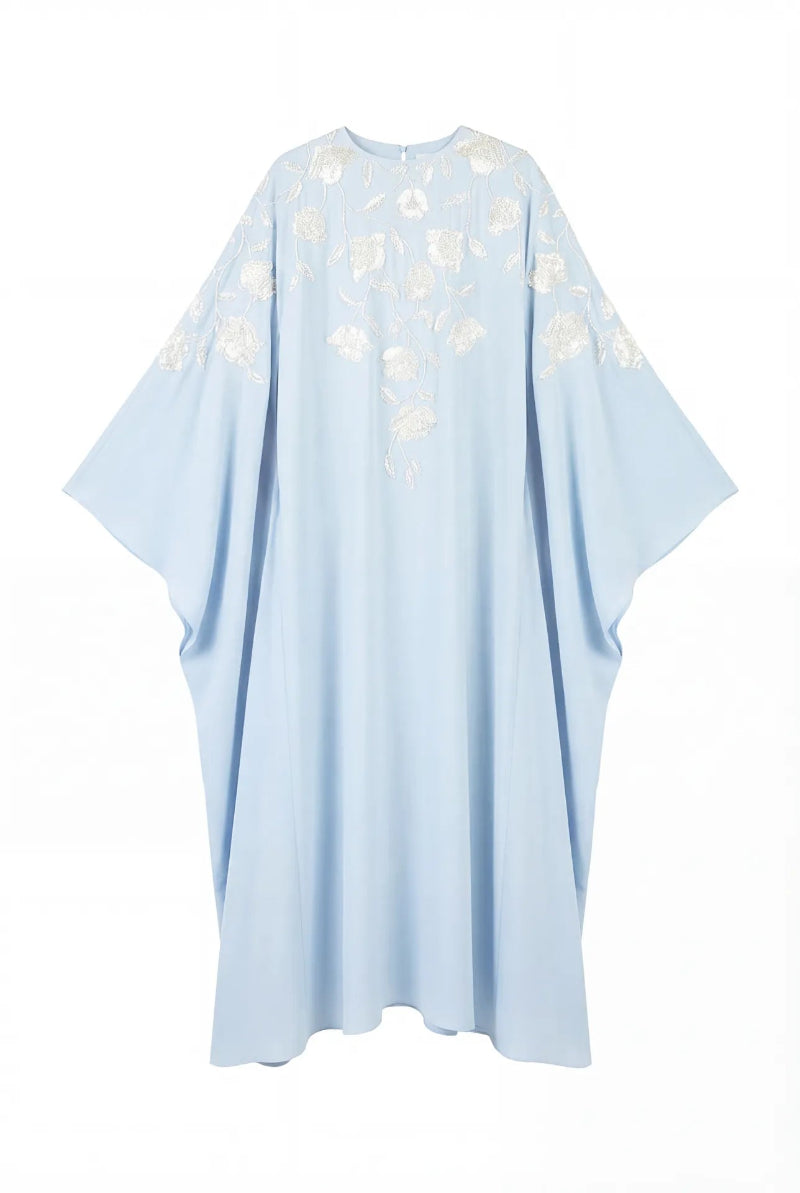 Light blue floral embellished maxi dress by Shatha Essa with intricate floral details and flowing fabric.