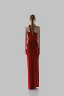 Red Baobab CELELE maxi dress displayed on a hanger, featuring flowing fabric and stylish design suitable for casual or dressy occasions.