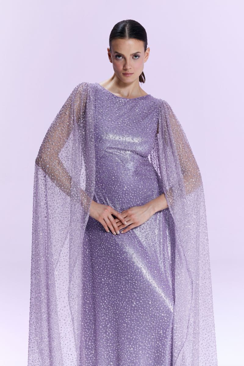 Nur Karaata La Mamounia purple gown with flowing fabric and elegant design, displayed on a mannequin.