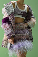 Lalo Avril mini skirt in purple multi with a fitted waist and stylish pattern, shown on a model.