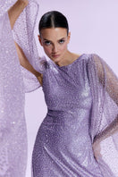 Nur Karaata La Mamounia purple gown with flowing fabric and elegant design, showcased on a model against a neutral background.