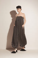 Black Valenciani jumpsuit shown on a hanger with a fitted silhouette and sleek design.