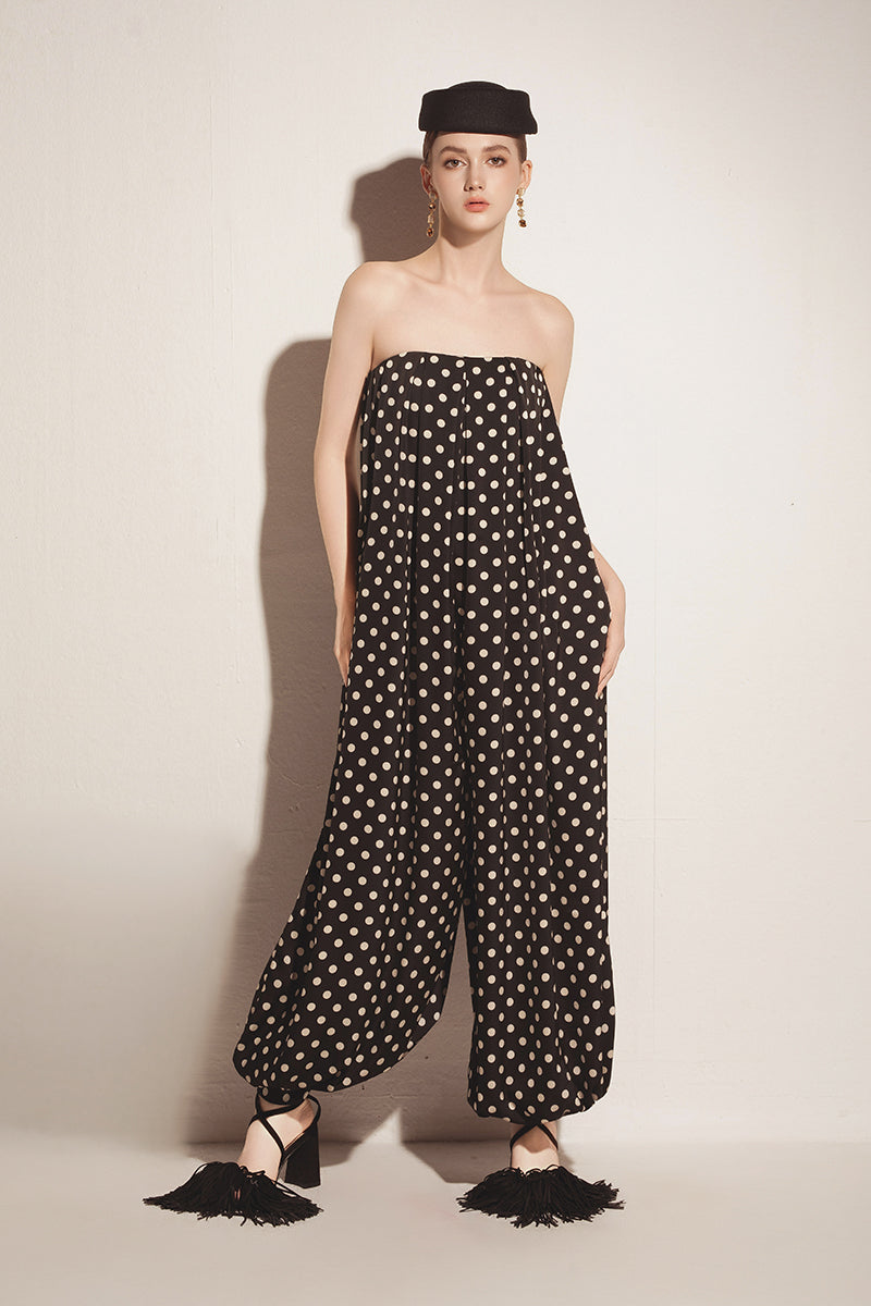 Black Valenciani jumpsuit with a sleek fit, featuring wide legs and a stylish neckline, perfect for modern, chic outfits.