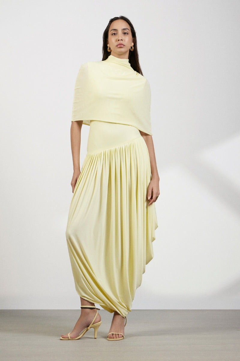 Deme By Gabriella Penelope yellow maxi dress with flowing fabric and sleeveless design, displayed on a dress form.
