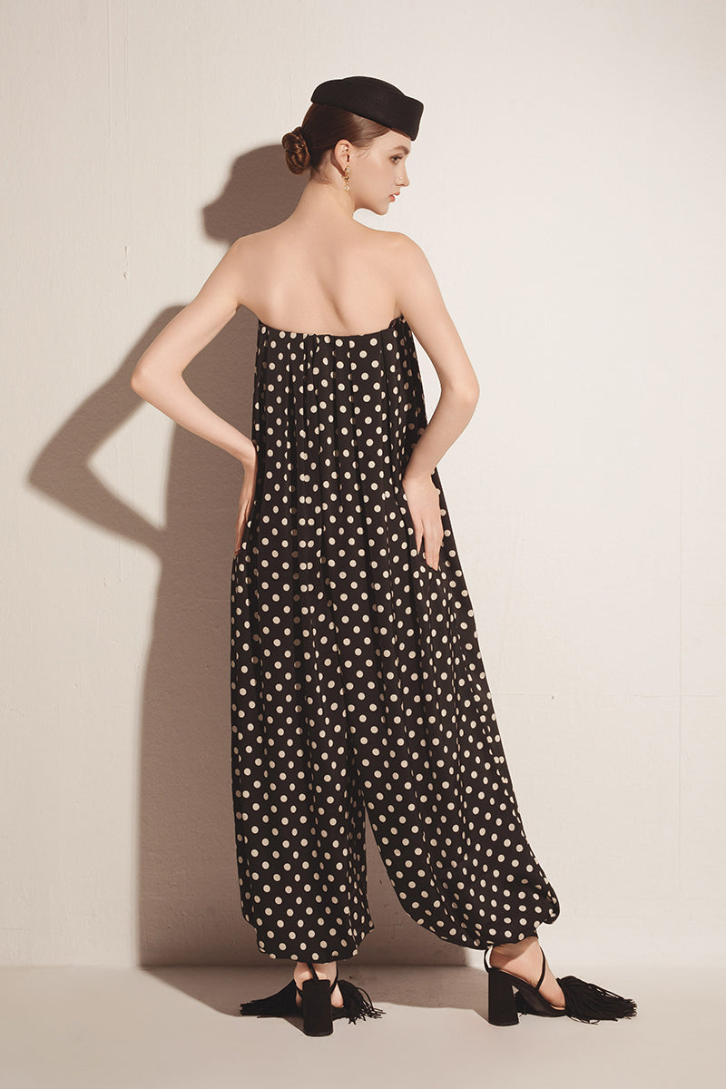 Black Valenciani jumpsuit with wide-leg design, featuring a sleeveless style and fitted waist, shown on a model.