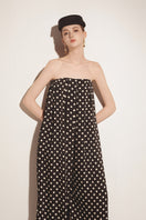 Black Valenciani jumpsuit with a fitted silhouette, featuring a stylish neckline and long sleeves, displayed on a mannequin.