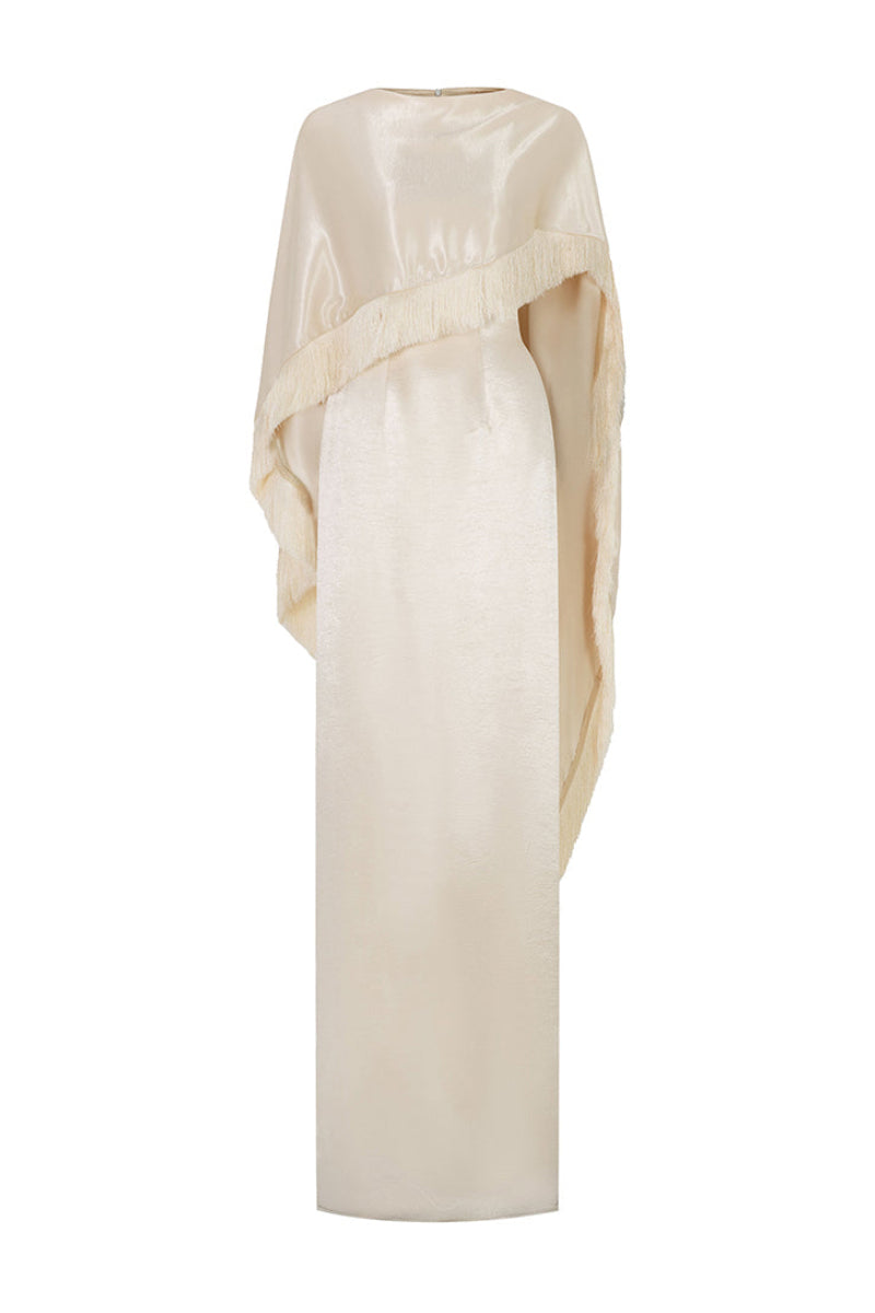Cream Valenciani column gown with fringed trim cape, featuring elegant draping and intricate detailing on the fabric.