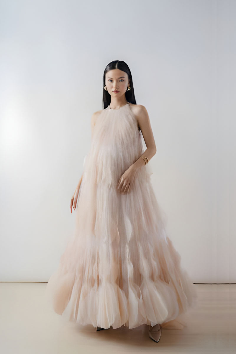 Beige halter neck tiered pleated tulle maxi dress by DOC BAN, featuring flowing layers and elegant design.