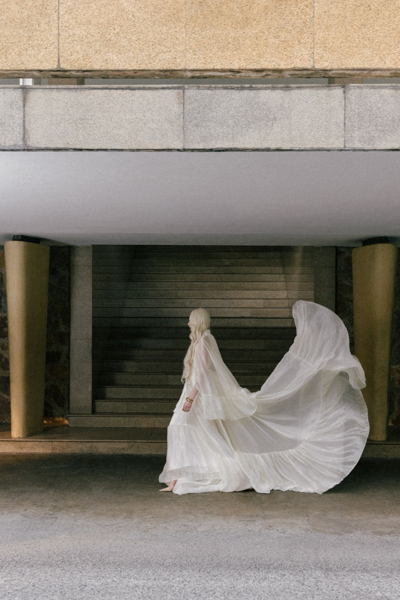 White Plan Antonia Maxi Dress displayed on a hanger, featuring a flowing, elegant design perfect for summer or casual occasions.
