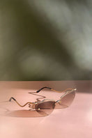 Brown Forget Me Not sunglasses by Moy Atelier featuring round frames and stylish tinted lenses.
