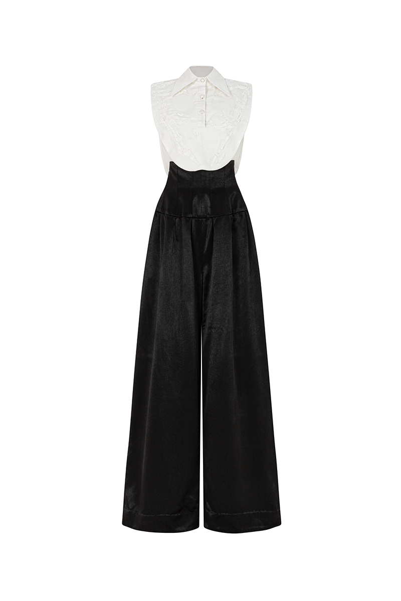 Black POEM AETHER trousers shown on a model, featuring a sleek, modern design with tailored fit and stylish detailing.