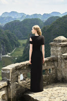 Black stone orchid asymmetric shoulder gown with matching cape by Tracy Studio, featuring elegant draped fabric and intricate detailing.