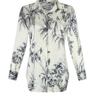 Aguaclara Grasse Bleue blouse, stylish shirt with blue floral pattern, displayed on a hanger with natural lighting.