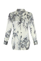 Aguaclara Grasse Bleue blouse, stylish shirt with blue floral pattern, displayed on a hanger with natural lighting.