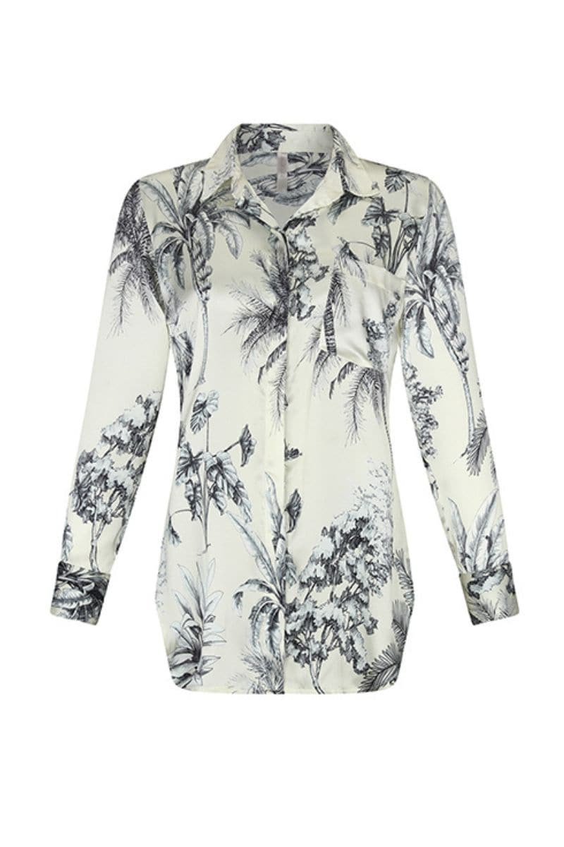 Aguaclara Grasse Bleue blouse, stylish shirt with blue floral pattern, displayed on a hanger with natural lighting.
