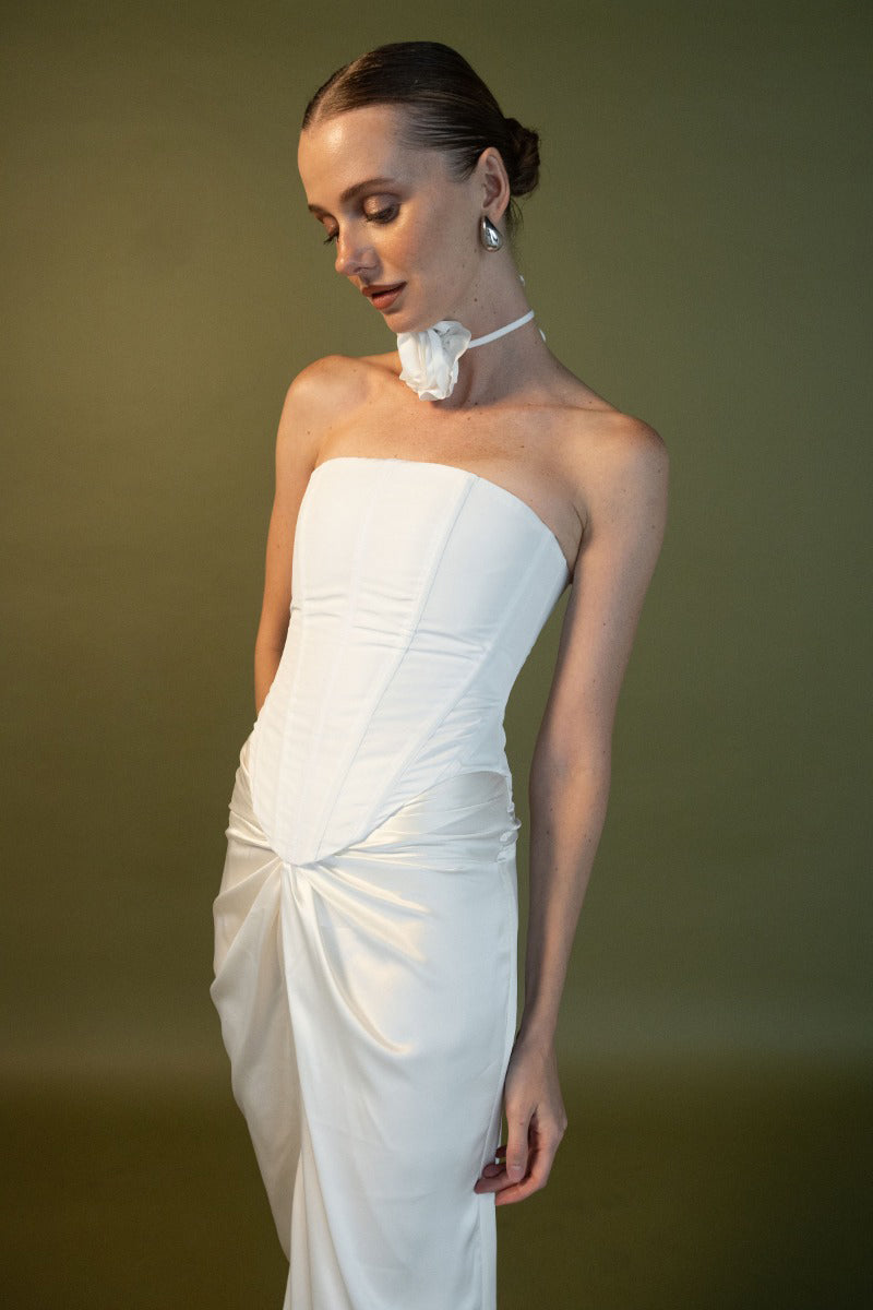 White Estefania anniversary corset top with lace details, fitted design, and adjustable straps.