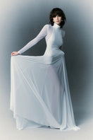 White Plan Nirvana Dress gown with flowing fabric and elegant design, showcased on a model.