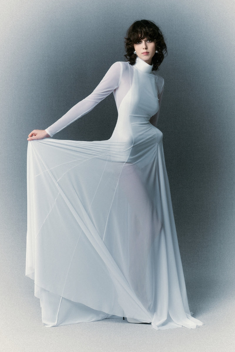 White Plan Nirvana Dress gown with flowing fabric and elegant design, showcased on a model.