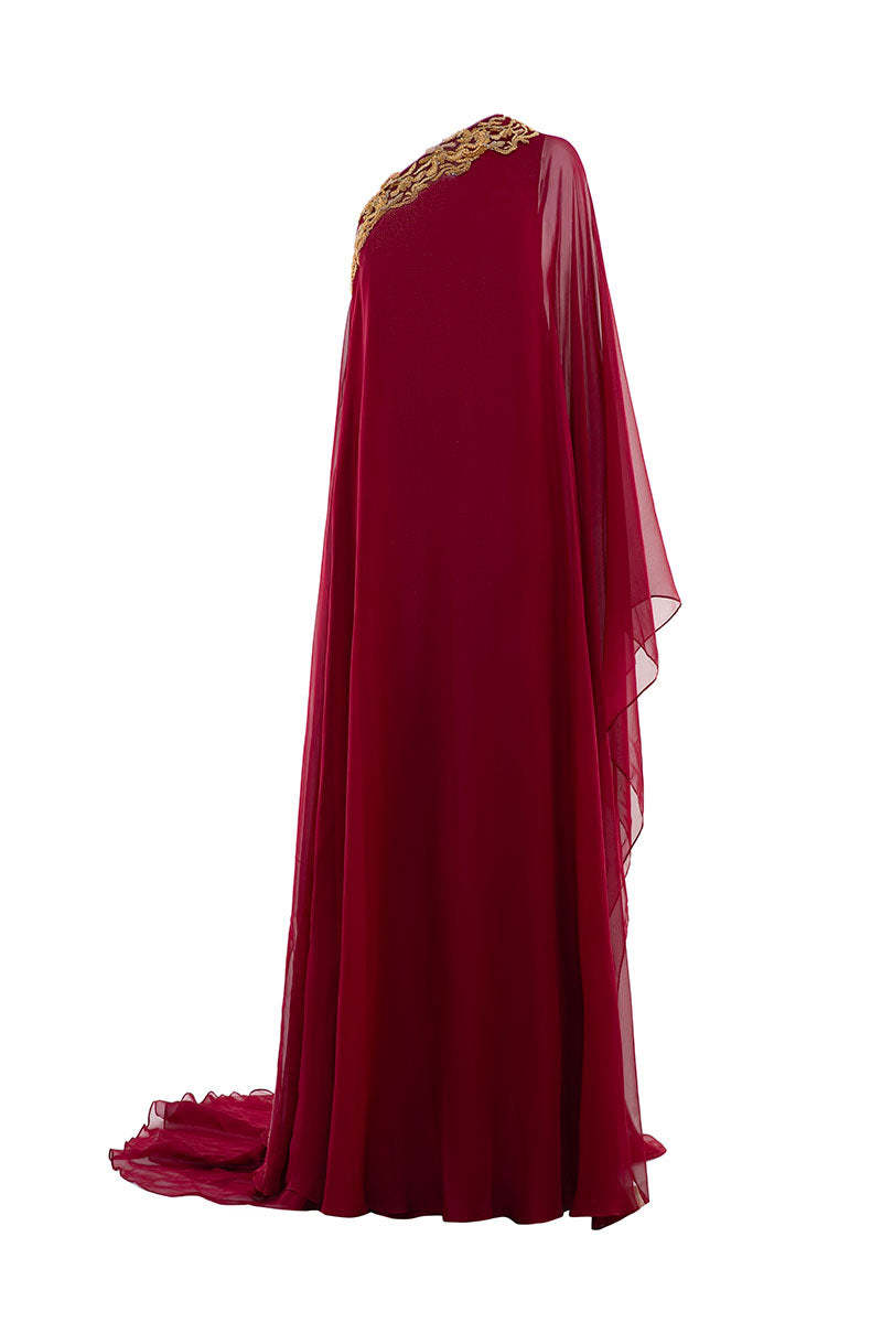 Le Thanh Hoa burgundy flow gown with elegant fabric and flowing design, displayed on a mannequin.