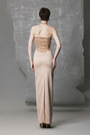 Gold long bodycon gown with sculpted bust by Phan Huy, elegant evening dress featuring fitted silhouette and stylish design.