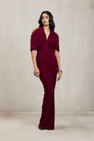 Deme By Gabriella Kimberly aubergine maxi gown, flowing elegant dress with long sleeves and a fitted waist on a model.