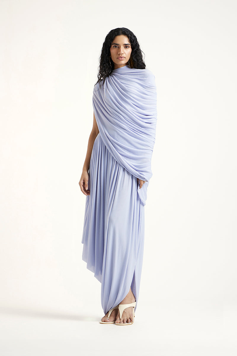 Deme By Gabriella Kyra Maxi Dress in periwinkle color, flowing fabric with a stylish design, displayed on a hanger.