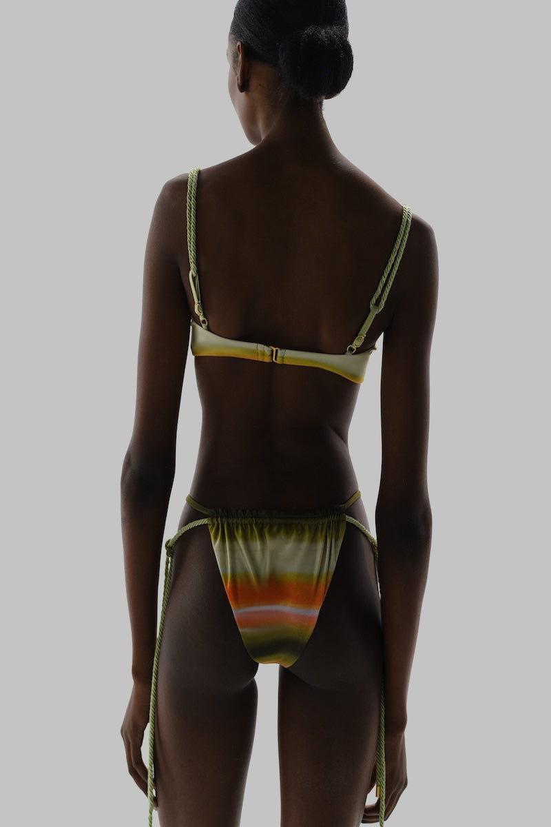 Baobab Lula bikini top in vibrant print, featuring adjustable straps and supportive design, perfect for beach or pool days.