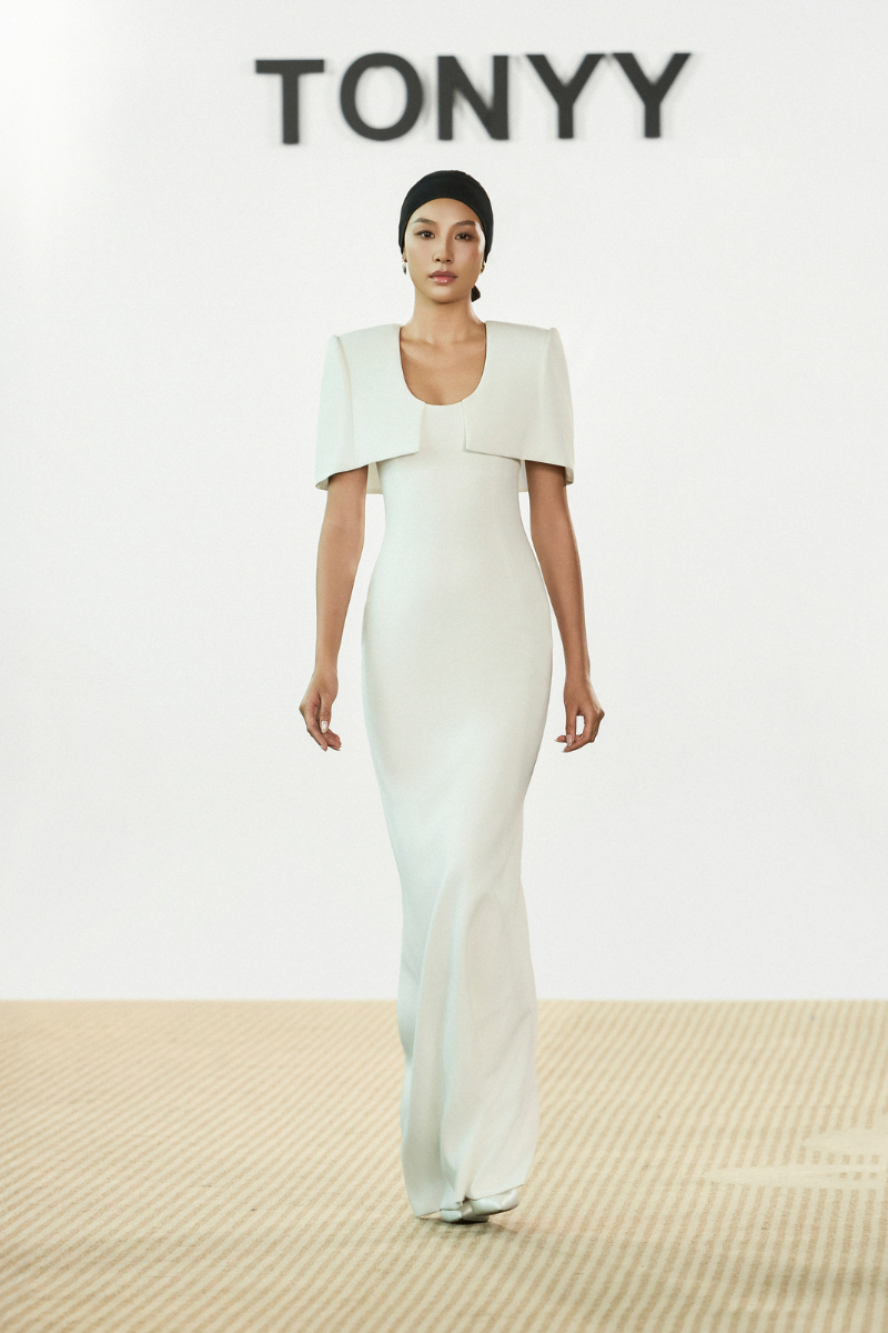 Silken Whisper gown by TONYY, elegant long gown with flowing fabric and delicate details, perfect for formal occasions.