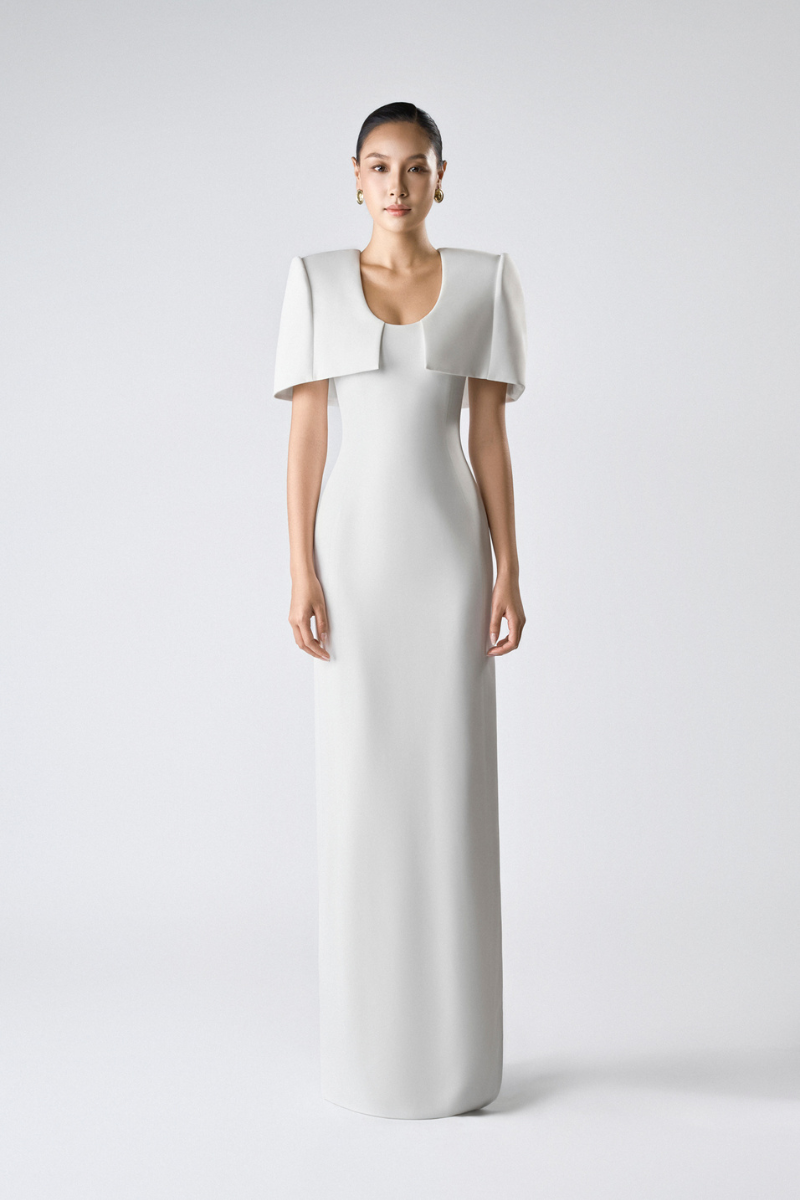 Elegant SILKEN WHISPER GOWN by TONYY, featuring flowing fabric and delicate design, perfect for formal occasions.