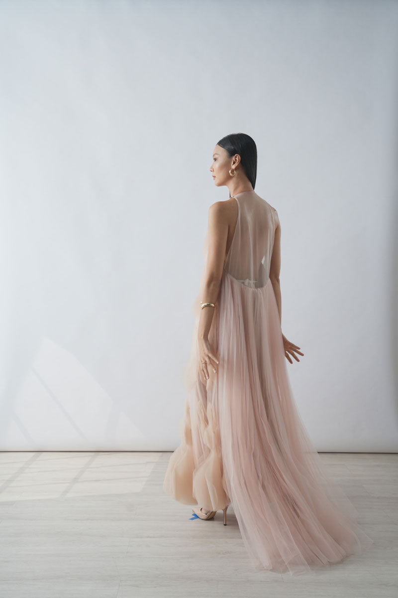 Beige halter neck tiered pleated tulle maxi dress by DOC BAN, featuring flowing layers and a stylish halter neckline.