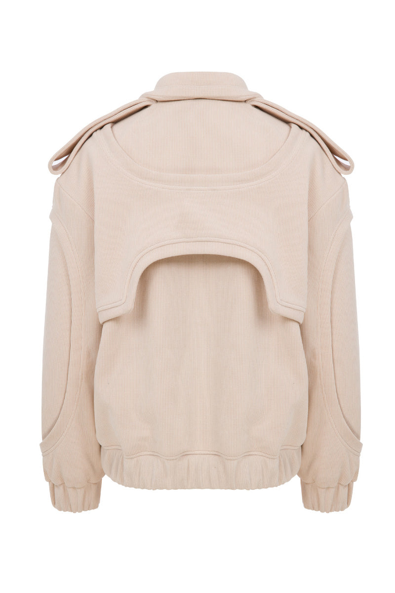 Cream ColoReve Soft Cave Biker Jacket showing its relaxed fit and textured fabric on a hanger.