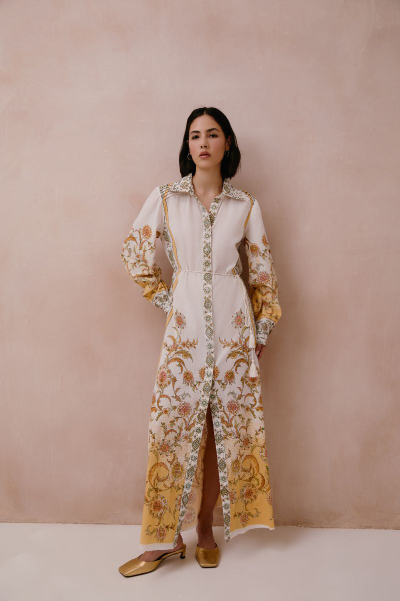 Yellow Briar midi dress by Raishma featuring a fitted bodice and flowing skirt, displayed on a hanger.