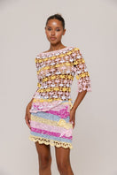 Handmade mini crochet skirt inspired by bird of paradise design from Andreeva, featuring colorful, intricate detailing and a fitted silhouette.