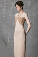 Gold long bodycon gown with sculpted bust by Phan Huy, featuring a fitted silhouette and elegant design.