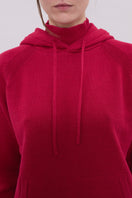 La Granni burgundy knitted roll neck hoodie sweater showing the cozy, textured fabric and high collar design.
