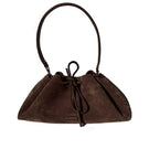 Rose de Mai Arabesque bucket shoulder bag in chocolate brown with rounded shape and adjustable strap.